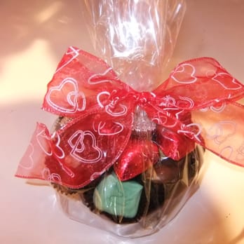 Sweet's - a cupcake wrapped in plastic with a red bow - Candy Stores Near Me - Lake Forest, Illinois