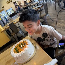 They wrote on a cake for his bday. Yummy mango cake