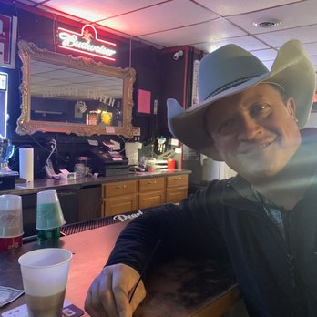 Hickory Tavern - a man in a cowboy hat sitting at a bar - Dive Bars Near Me - Saint Joseph, Missouri