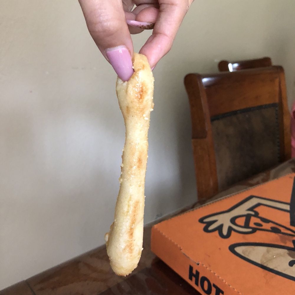 Little Caesars Pizza - a hand holding a piece of bread - Pizza Near Me - Port Arthur, Texas Little Caesars Pizza - a hand holding a piece of bread - Pizza Near Me - Port Arthur, Texas