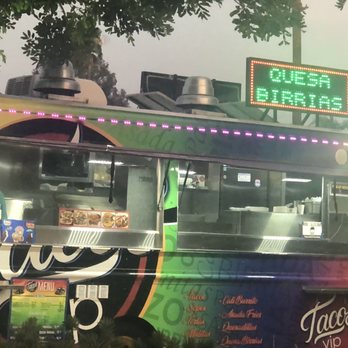 Tacos VIP - a colorful food truck with neon signs - Food Trucks Near Me