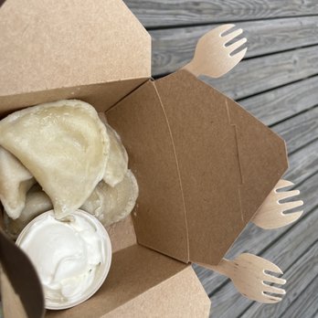 The Pierogie Place - a person holding a box of food - Modern European Near Me - Ocean City, New Jersey The Pierogie Place - a person holding a box of food - Modern European Near Me - Ocean City, New Jersey
