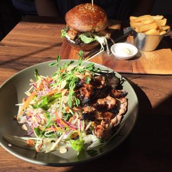 White Taro Cafe - Grilled chicken salad and the chicken in black brioche in the background
