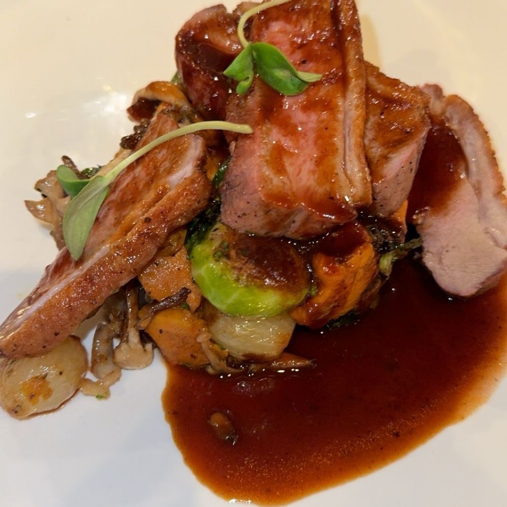 Pan Roasted Duck Breast Two ways Duck Breast. Sweet Potato Hash, Brussels Sprouts, Onions, Wild Mushrooms, Topped with Quince Red Wine Sauce