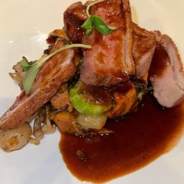 Pan Roasted Duck Breast Two ways Duck Breast. Sweet Potato Hash, Brussels Sprouts, Onions, Wild Mushrooms, Topped with Quince Red Wine Sauce