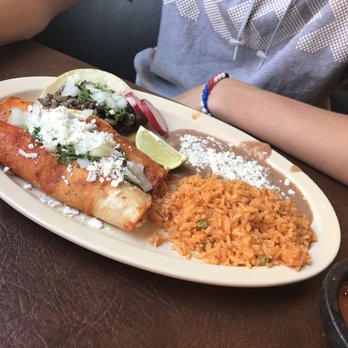 Tacos El Rey - Enchilada and taco combo with son trying the habenero sauce on it! Good luck son! - Mexican Near Me - Reno, Nevada Tacos El Rey - Enchilada and taco combo with son trying the habenero sauce on it! Good luck son! - Mexican Near Me - Reno, Nevada