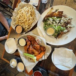 Chicken wings, steak bites and blue cheese salad, fries