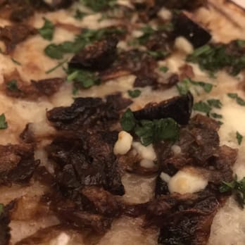 True Food Kitchen - Caramelized onion tart close-up - New American Near Me - Denver, Colorado True Food Kitchen - Caramelized onion tart close-up - New American Near Me - Denver, Colorado