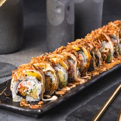 Evva Miami - APOCALIPSIS ROLL - SHRIMP TEMPURA, CRAB SALAD, AVOCADO, TOPPED WITH SWEET PLANTAIN, PASSION FRUIT SAUCE AND SPICY MAYO.