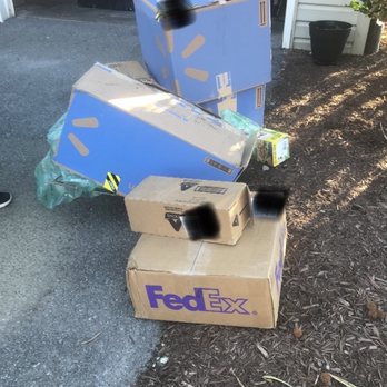FedEx Ship Center - Packages thrown into the mulch by the garage door - Shipping Centers Near Me - Winchester, Virginia