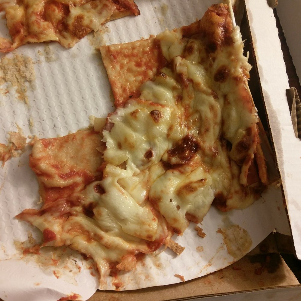 a half eaten pizza in a box