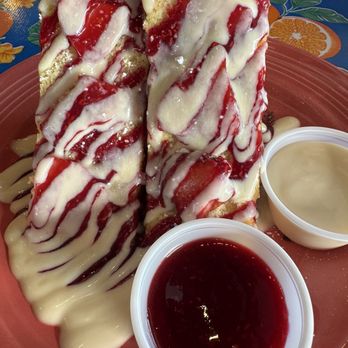 The Flying Biscuit Cafe - Front side of the sweet cream cheese stuffed French toast with raspberry sauce and crème anglaise to use as a dip. - Southern Near Me - Houston, Texas The Flying Biscuit Cafe - Front side of the sweet cream cheese stuffed French toast with raspberry sauce and crème anglaise to use as a dip. - Southern Near Me - Houston, Texas
