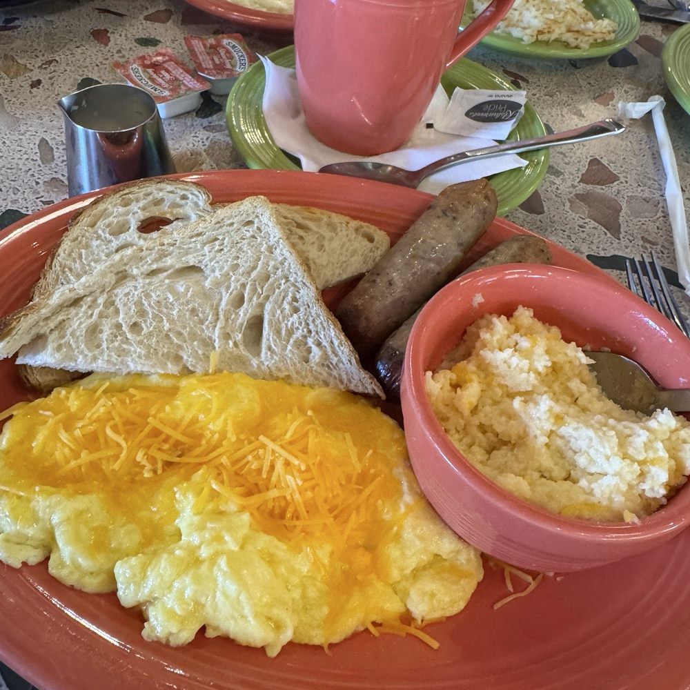 The Usual with sourdough toast, chicken cranberry sausage, cheese grits, slow scramble eggs with cheese, and pecan coffee.