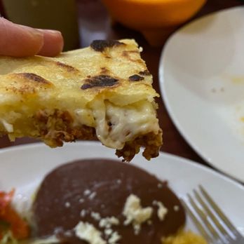Pupuseria Salvadorena - a hand holding a piece of quesadilla - Salvadoran Near Me - Nashville, Tennessee Pupuseria Salvadorena - a hand holding a piece of quesadilla - Salvadoran Near Me - Nashville, Tennessee