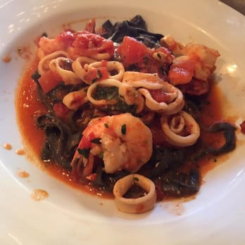 Pepe Giallo - Black fettuccine with seafood in a light tomato sauce. - Italian Near Me - New York, New York Pepe Giallo - Black fettuccine with seafood in a light tomato sauce. - Italian Near Me - New York, New York
