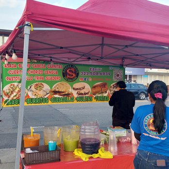Shekos Tacos - a group of people standing under a tent - Tacos Near Me - Los Angeles, California