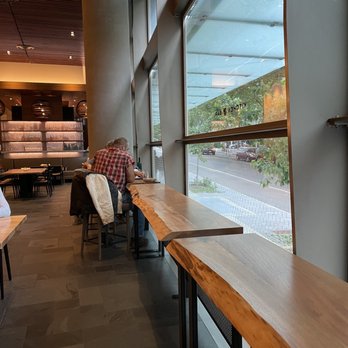 Andare Kitchen & Bar - a man sitting at a table - Pizza Near Me - Seattle, Washington
