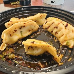 Chicken gyoza with chili oil. Chicken gyoza with chili oil.
