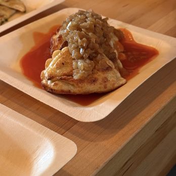 Ripple Wine Bar - Covington - Pierogies with caramelized onions on top and a hot sauce underneath. - Wine Bars Near Me - Covington, Kentucky Ripple Wine Bar - Covington - Pierogies with caramelized onions on top and a hot sauce underneath. - Wine Bars Near Me - Covington, Kentucky
