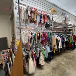 Kids section. I got several like new NB onesies for $1. & $2. Larger sizes to the right w/ girls clothes on another rack.