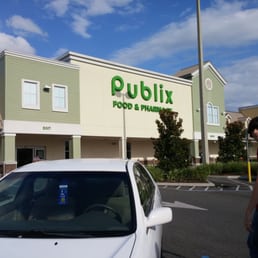 a man standing in front of a white car