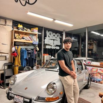 Dodi Auto Sales - Me inside the shop taking a picture next to a vintage classic - Car Dealers Near Me - Monterey, California