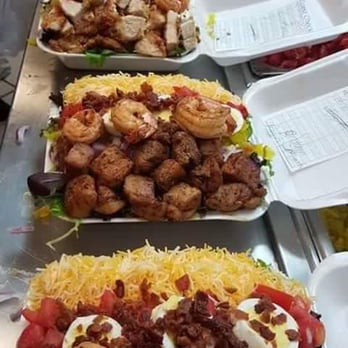 Draeona's Family Seafood - a long line of trays of food - Seafood Near Me - Buffalo, New York Draeona's Family Seafood - a long line of trays of food - Seafood Near Me - Buffalo, New York