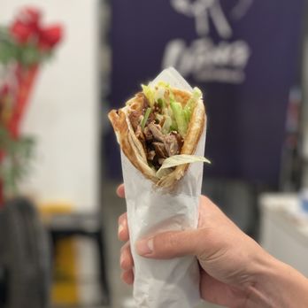 Liang Crispy Roll - a hand holding a sandwich - Juice Bars & Smoothies Near Me - Rowland Heights, California