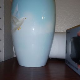 Beautiful urn with a white dove on it.