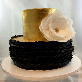 MiGoodies BakeSale - Top layer is Pistashio, butter cream with gold leaf detail. Bottom is oreo cookie with black fondant ruffles and a wafer paper flower. - Bakeries Near Me MiGoodies BakeSale - Top layer is Pistashio, butter cream with gold leaf detail. Bottom is oreo cookie with black fondant ruffles and a wafer paper flower. - Bakeries Near Me