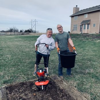 Bloom KS - a man and a woman standing next to a garden bed - Landscaping Near Me Bloom KS - a man and a woman standing next to a garden bed - Landscaping Near Me