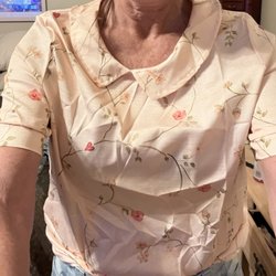 This is the photo with collar off center, material is uncomfortable and cheap, and sleeves completely different. Obviously not wearable.