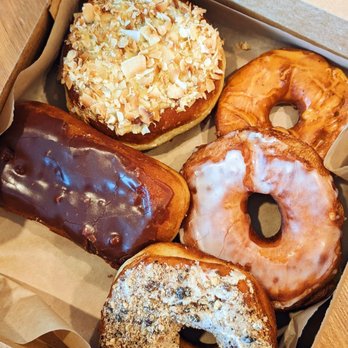 Raised Doughnuts and Cakes - Mango coconut, chocolate bar, thai tea mochi, glazed, chocolate chip cookie - Donuts Near Me - Seattle, Washington Raised Doughnuts and Cakes - Mango coconut, chocolate bar, thai tea mochi, glazed, chocolate chip cookie - Donuts Near Me - Seattle, Washington
