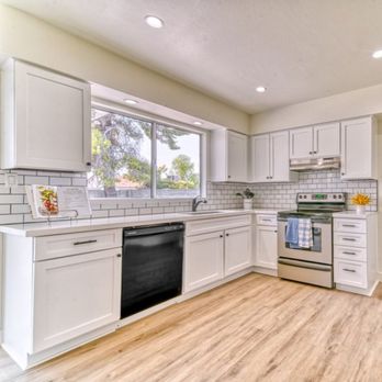 Redemption Renovations - a clean kitchen with white cabinets and stainless steel appliances - Cabinetry Near Me - Phoenix, Arizona