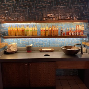 Nando's Peri-Peri - Sauce and sink to wash hands - South African Near Me - Reston, Virginia Nando's Peri-Peri - Sauce and sink to wash hands - South African Near Me - Reston, Virginia