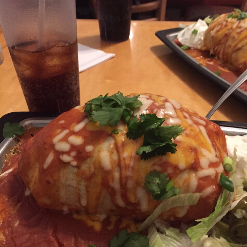 Back 40 Urban Cafe - Wet burrito...this is densely packed about to pop...I don't know how some people can fit a whole one inside of them. - Caribbean Near Me - St. Augustine, Florida