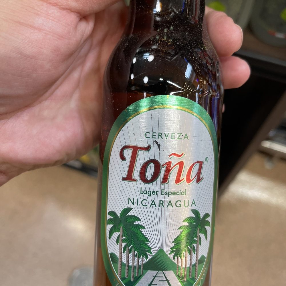 Taqueria Gonzalez - a person holding a bottle of beer - Mexican Near Me - Fontana, California Taqueria Gonzalez - a person holding a bottle of beer - Mexican Near Me - Fontana, California