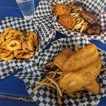 Shipwreck Lee's - 1 piece White Fish & Chips (Bottom), Jerk Chicken (Top, comes with corn & fries), Calamari as side (Left). - Fish & Chips Near Me - Tobermory, Ontario Shipwreck Lee's - 1 piece White Fish & Chips (Bottom), Jerk Chicken (Top, comes with corn & fries), Calamari as side (Left). - Fish & Chips Near Me - Tobermory, Ontario