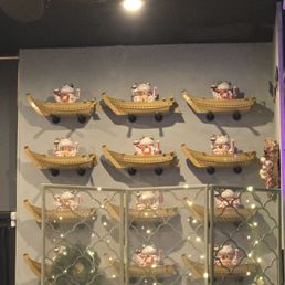 Wall of kitties on boats, along with other traditional decor. Wall of kitties on boats, along with other traditional decor.