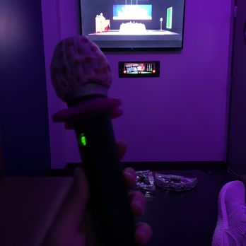 Kpop karaoke - a person holding a microphone in front of a tv - Karaoke Near Me - Annandale, Virginia Kpop karaoke - a person holding a microphone in front of a tv - Karaoke Near Me - Annandale, Virginia