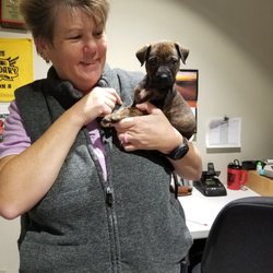 Tractor Supply - Manager Tonia with 8 week old puppy Willow.