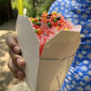 SnoRide - a person holding a bag of candy - Shaved Ice Near Me - Austin, Texas SnoRide - a person holding a bag of candy - Shaved Ice Near Me - Austin, Texas