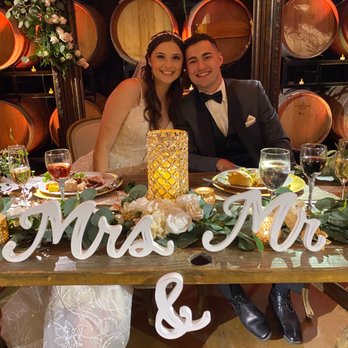 Madam Palooza - Sweetheart table - chairs and frame behind the Bride and Groom - Party Equipment Rentals Near Me - Murrieta, California Madam Palooza - Sweetheart table - chairs and frame behind the Bride and Groom - Party Equipment Rentals Near Me - Murrieta, California