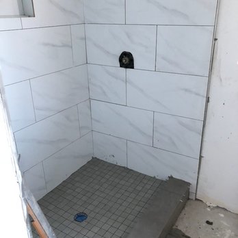 Aris Construction & Design - a shower in a bathroom being remodeled - General Contractors Near Me