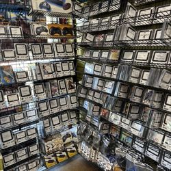 Wall of games mostly without original packaging