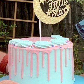 Dolce De Luca Bake Shop - a person holding a cake - Bakeries Near Me