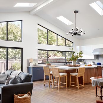 EDR Design Build - Beautiful Open Kitchen & Living room, featuring big skylights, big windows, bi-fold door, kitchen island, and a fireplace in the living room - General Contractors Near Me - Los Gatos, California EDR Design Build - Beautiful Open Kitchen & Living room, featuring big skylights, big windows, bi-fold door, kitchen island, and a fireplace in the living room - General Contractors Near Me - Los Gatos, California