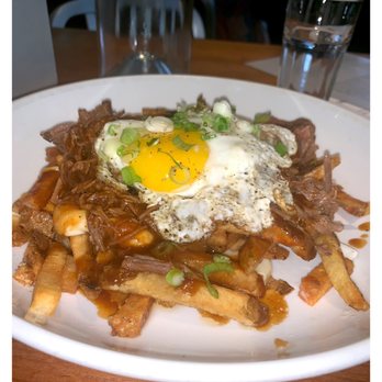 Leon's Full Service - Beef Poutine- Fries, sunny side farm egg, cheese curds and peppercorn gravy. - Gastropubs Near Me - Decatur, Georgia Leon's Full Service - Beef Poutine- Fries, sunny side farm egg, cheese curds and peppercorn gravy. - Gastropubs Near Me - Decatur, Georgia