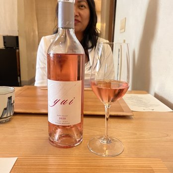 Kenzo Napa - a woman sitting at a table with a glass of wine - Sushi Bars Near Me - Napa, California Kenzo Napa - a woman sitting at a table with a glass of wine - Sushi Bars Near Me - Napa, California