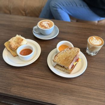 Penny University - Bacon breakfast sandwich, biscuit and jam, cappuccino and cortado. - Coffee & Tea Near Me - Modesto, California Penny University - Bacon breakfast sandwich, biscuit and jam, cappuccino and cortado. - Coffee & Tea Near Me - Modesto, California